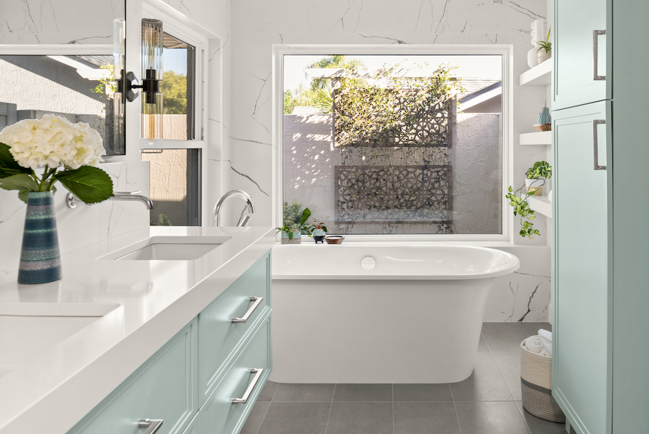 bathroom with large window over freestanding tub