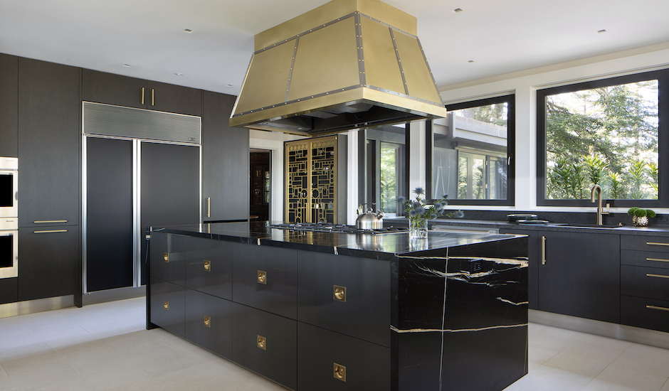 gold range hood over modern kitchen island