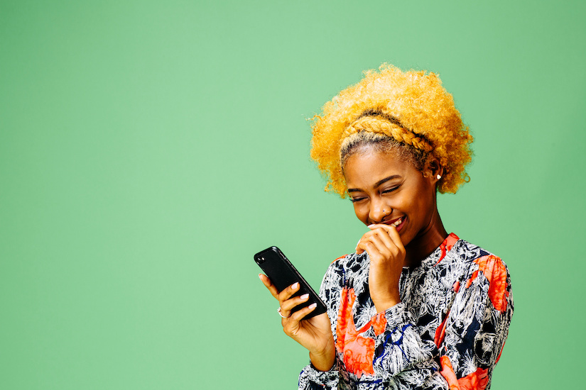 woman reading message on cell phone making emotional connection