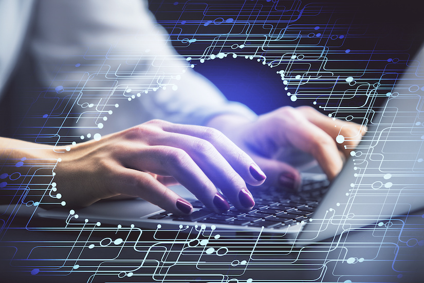 digital overlay on designer's hand at a computer