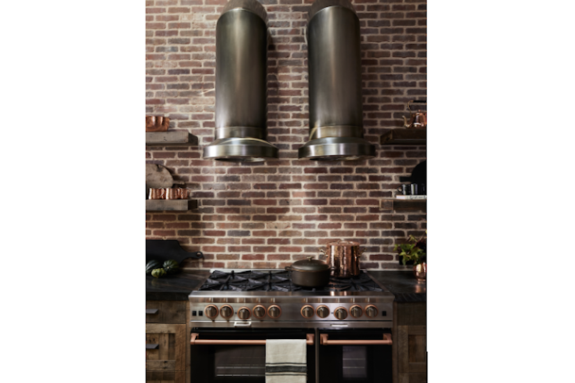 mixed metal range and vent hood in steampunk kitchen