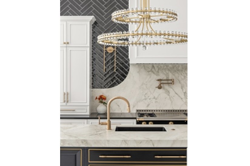 black and white kitchen with gold chandelier over island