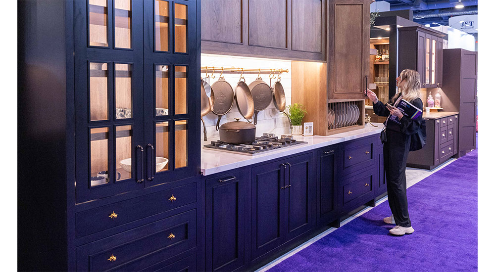 Countdown to KBIS 2025: an attendee looking at cabintry offerings