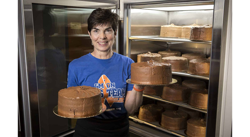 woman putting cakes in refrigerator at Clarke