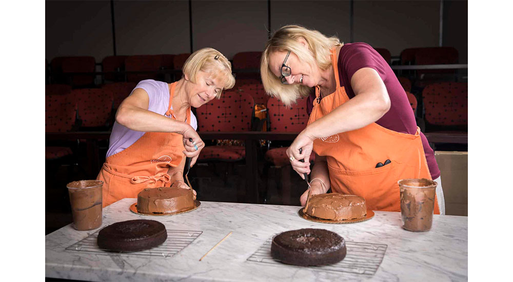 women frosting cakes