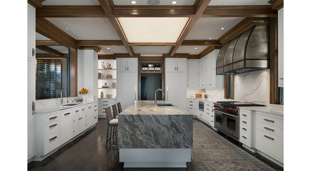 This kitchen by Deep River Partners features fully integrated Sub-Zero refrigerator and freezer columns, a 60-inch Wolf dual-fuel range with a dual griddle, a custom nickel range hood by Texas Lightsmith and a Wolf microwave drawer.