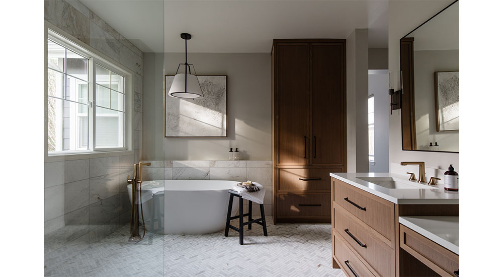primary modern organic bathroom with wood vanity and cabinet freestanding tub