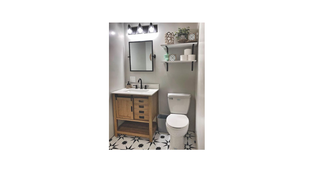vanity and saniflo toilet in bathroom