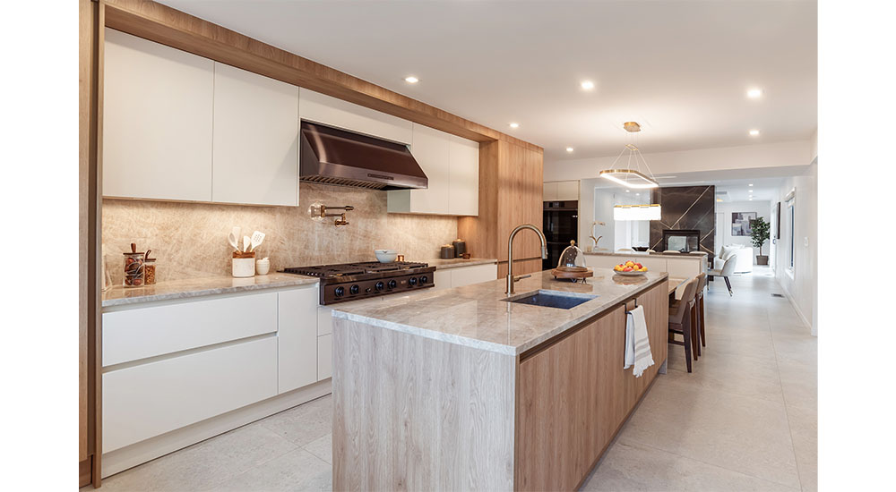 kitchen renovation island with stone waterfall and wooden base cabinets