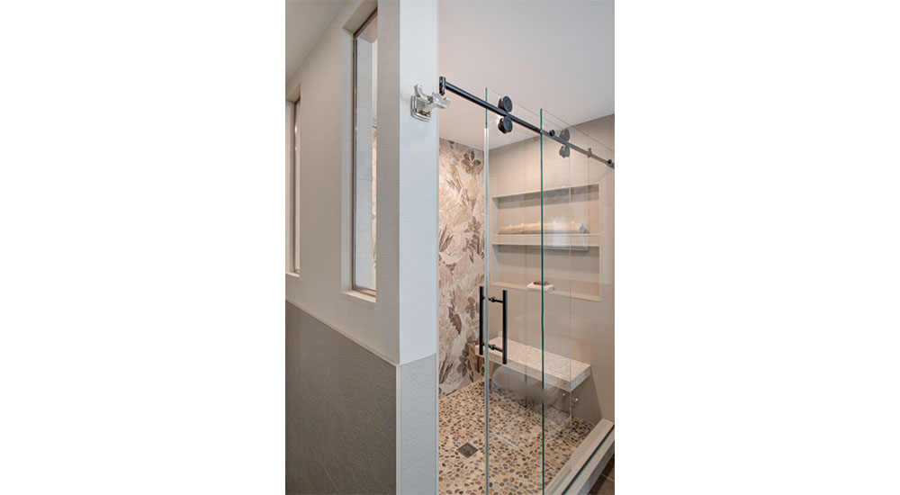 tiled shower with interior windows and rolling glass barn door