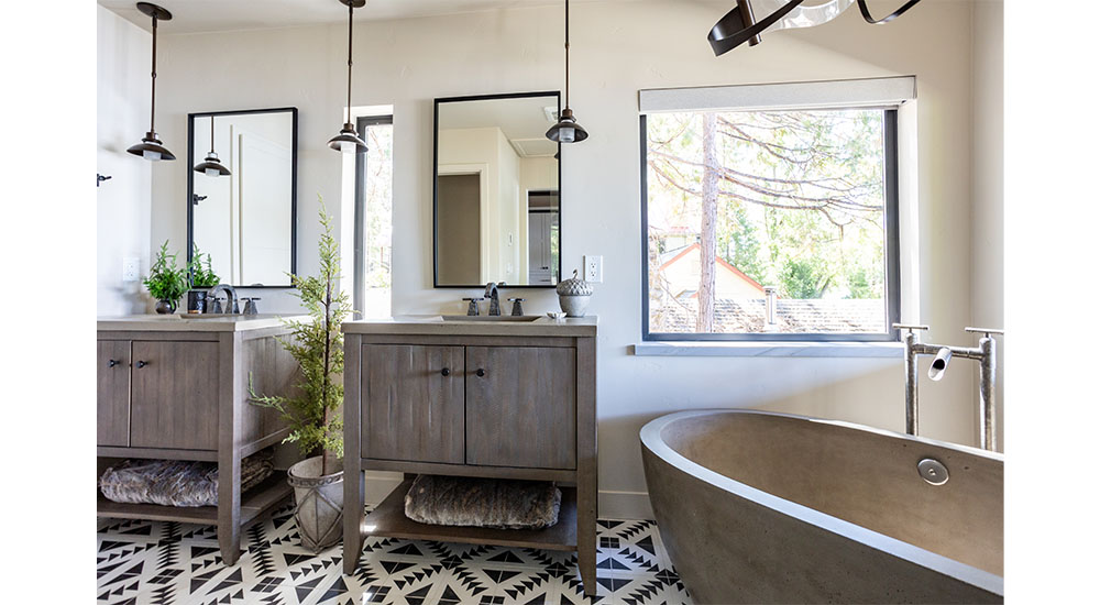 rustic primary bath with two vanities and freestanding tub