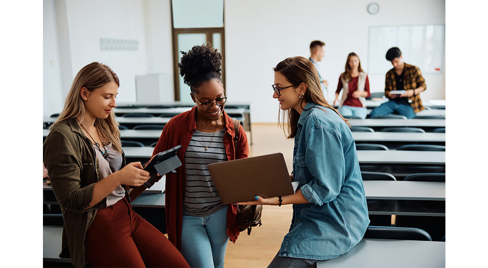 nkba students looking at laptops in classroom