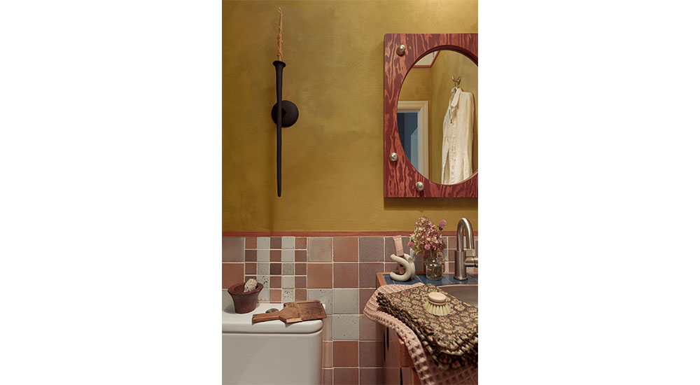 powder room with tile wainscoting, rustic mirror, candle on wall