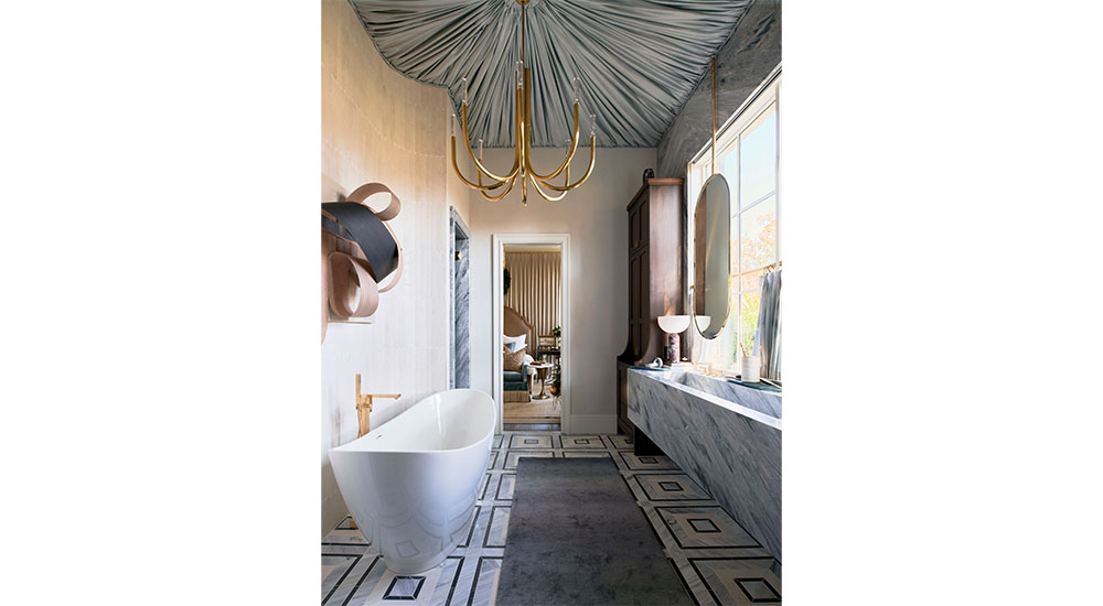 primary bath at designer showhouse in Atlanta with marble trough sink and freestanding tub