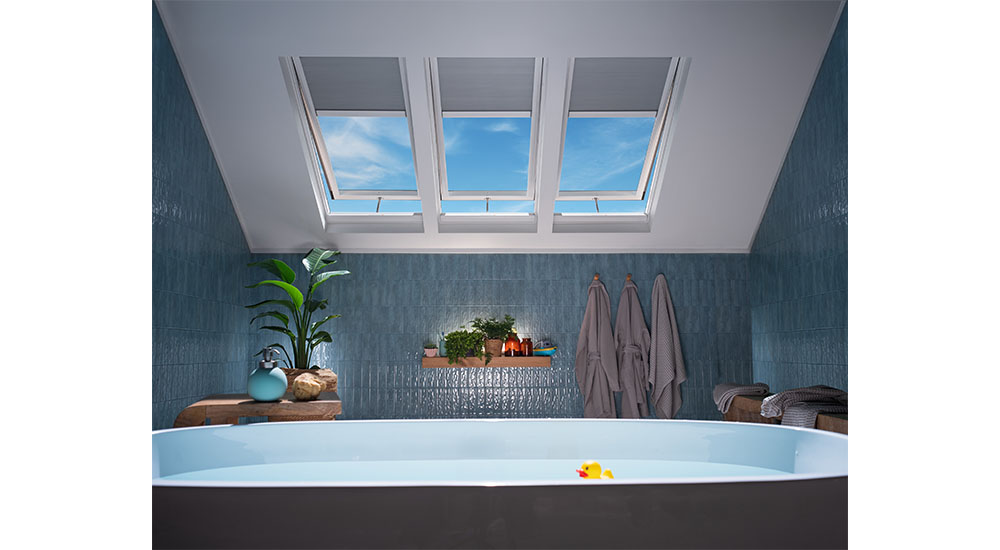 bathroom with three open operable skylights over tub