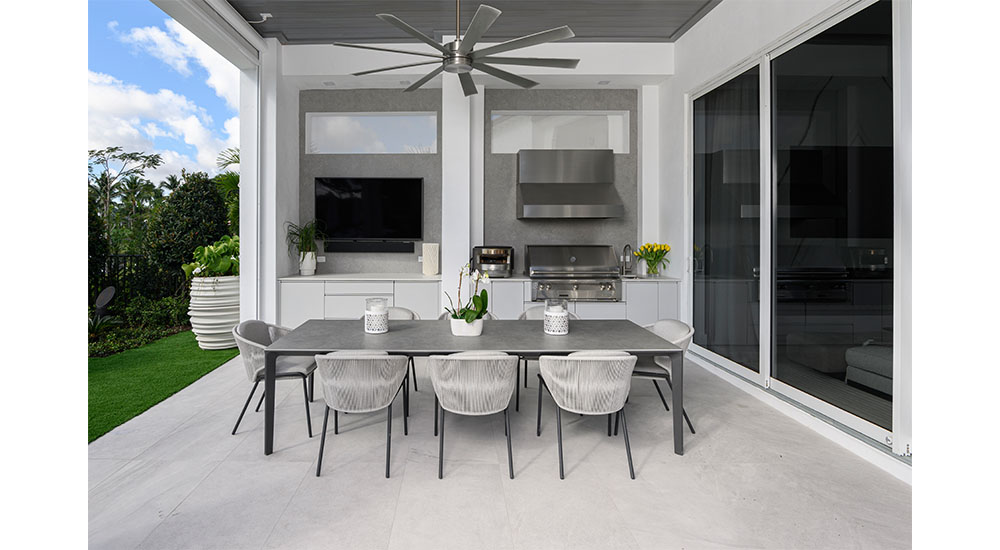 outdoor kitchen with grill, ceiling fan and dining table