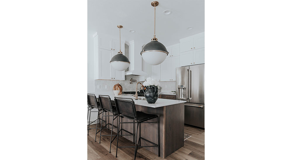 kitchen island with bar seating and globe pendant light fixtures